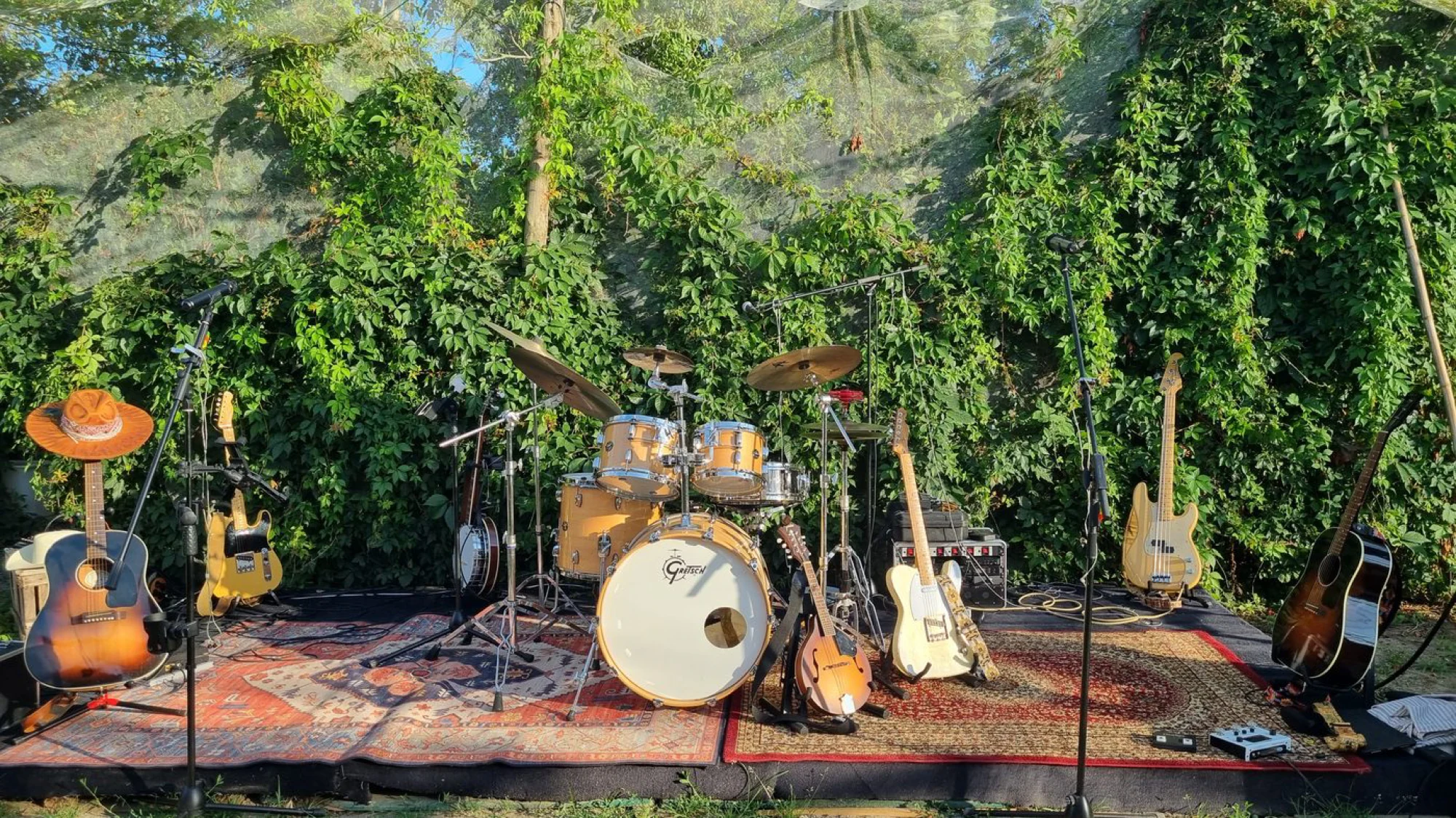 The Coffeekillers&rsquo; instruments ready on stage, surrounded by green